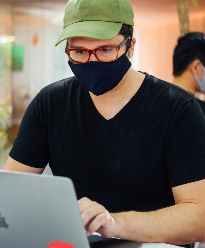 man working and wearing mask